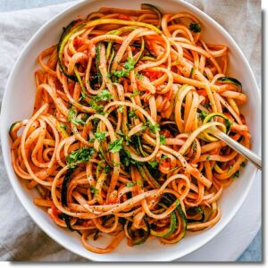 Vegetable spaghetti with arrabiatta and vegan parmesan